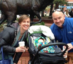 Matthew Hauptly and his wife, Eleanor, pose with their newborn son, Augustus. Hauptly was named principal of Holy Family High School in Broomfield.