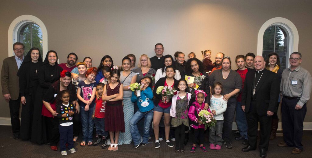 Mothers and families from Father Ed Judy House, a shelter for single mothers, were honored at a Mother’s Day dinner hosted by Archbishop Samuel Aquila at the St. John Paul II Center May 10.
