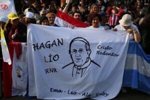 Women hold a banner with an image of Pope Francis in Caacupe, Paraguay during his visit July 11.