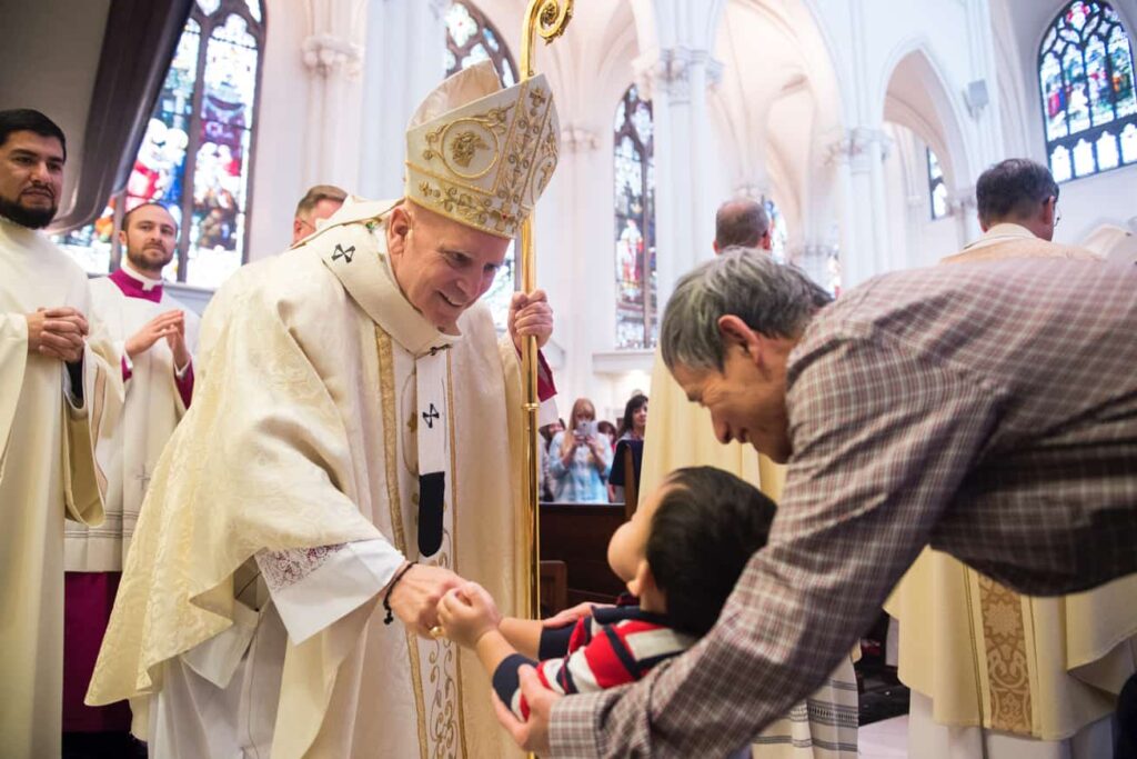 DENVER, CO, March 23, 2016 - Archbishop Samuel J. Aquila greets a young faithful during the Chrism Mass at the Cathedral Basilica of the Immaculate Conception. (Photo by Dan Petty/A&D Photography)