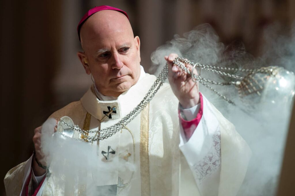 DENVER, CO, March 23, 2016 - Archbishop Samuel J. Aquila reverently blesses the holy oils with incense during the Chrism Mass. (Photo by Dan Petty/A&D Photography)