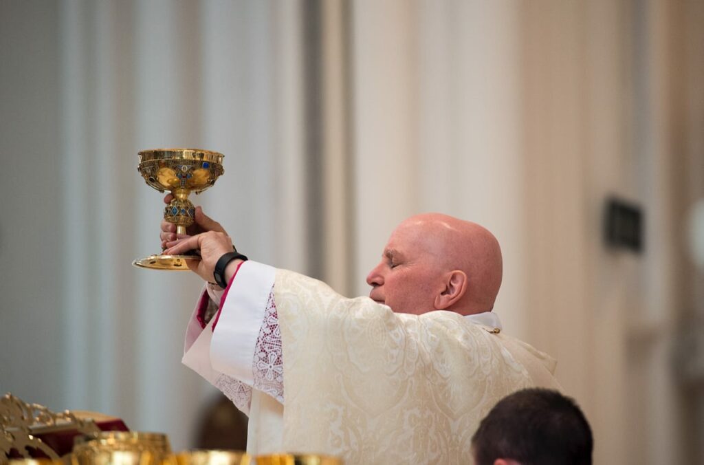 DENVER, CO, March 23, 2016 - Archbishop Samuel J. Aquila presents the wine for consecration during the Chrism Mass at the Cathedral Basilica of the Immaculate Conception. (Photo by Dan Petty/A&D Photography)