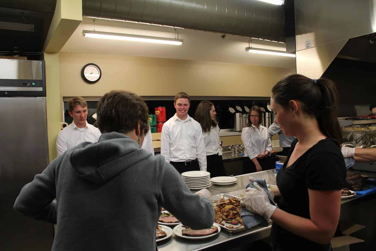 Students at Colorado School of Mines prepare to serve dinner to alumni members of the community. Professor Darrin Muggli also gave a talk on the importance of being a well-formed Catholic engineer. Photo provided.