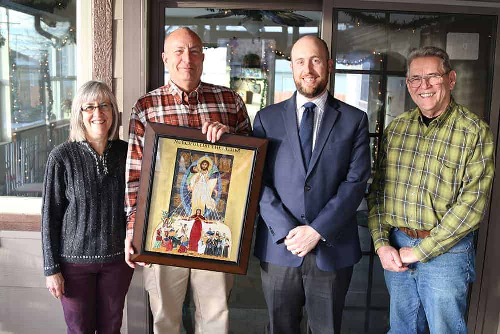 Mike Miller shows off his Year of Mercy icon with his wife Carol (Carol), Dave Uebbing (right), and Don Wolfe (far right). (Photo by Aaron Lambert)