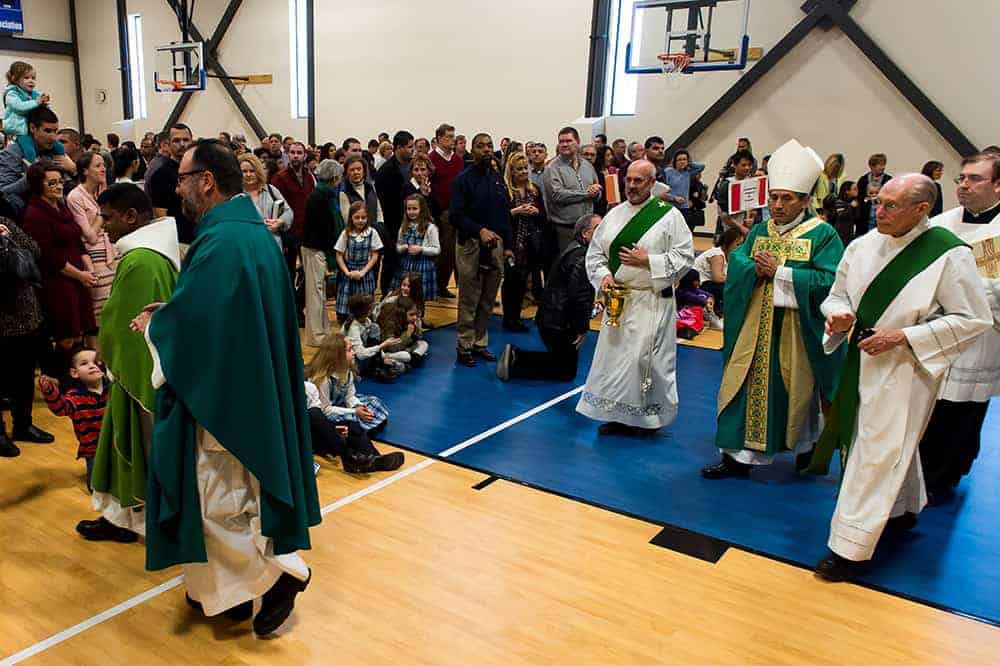 FOXFIELD, CO - JANUARY 29: Fr. David Bluejacket (L) and Denver Auxiliary Bishop Jorge Rodriguez (R) exit the new gymnasium after the dedication of the west wing of the St. Joseph Ministry Center and School Building at Our Lady of Loreto Catholic Parish and School on January 29, 2017, in Foxfield, Colorado. (Photo by Anya Semenoff/Denver Catholic)