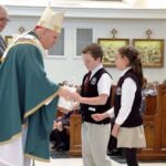 Archbishop Aquila hands out rosaries to 2 children selected from each school to distribute them during the 5th grade Liturgy held at the Cathedral of the Immaculate Conception in Downtown Denver, on Wed. Feb. 26th.
