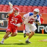 Ben Betcher of Regis Jesuit High School advances the ball against Cherry Creek in the 5A State LaCrosse Championship at Sports Authority Field at Mile High on Sat. May 17th. Regis won 14 – 7.