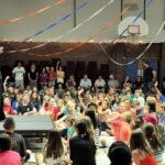 Jack Del Rio, Defensive Coordinator for the Denver Broncos, addresses the kids at Guppy Fest on Fri., June 6th. Guppy Fest was held at St. Thomas More in Englewood, Colorado.