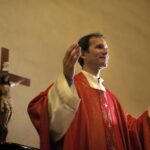 Catholic priest on altar praying during mass