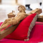 A cross rests on a pillow before being venerated during the celebration of the Lord’s Passion. Photo by Daniel Petty/Denver Catholic