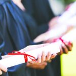Graduates with diplomas.